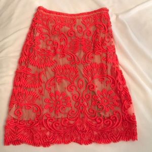 Embroidered orange skirt with tan lining.